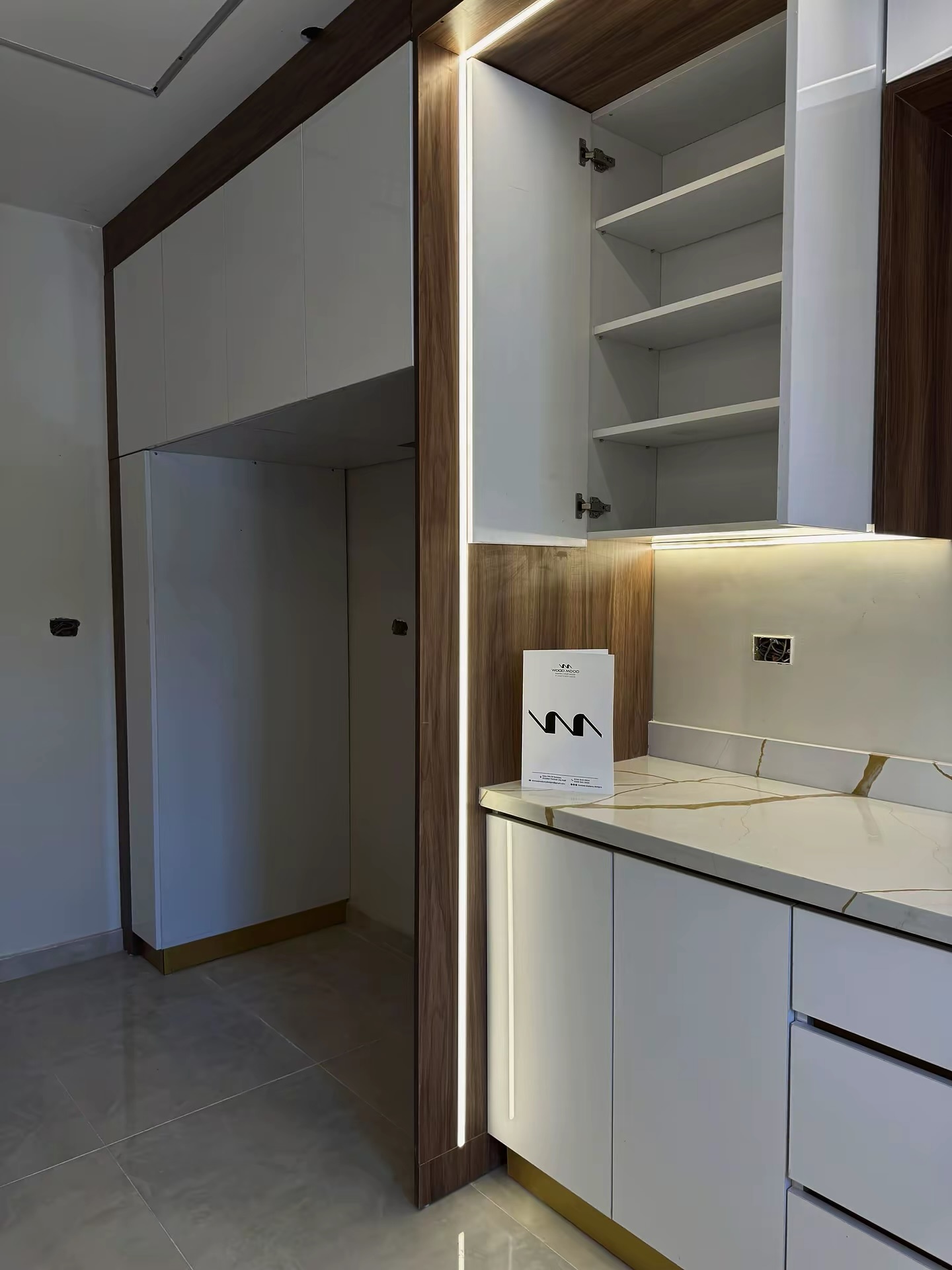 Kitchen with walnut column, integrated LED line and open upper cabinet